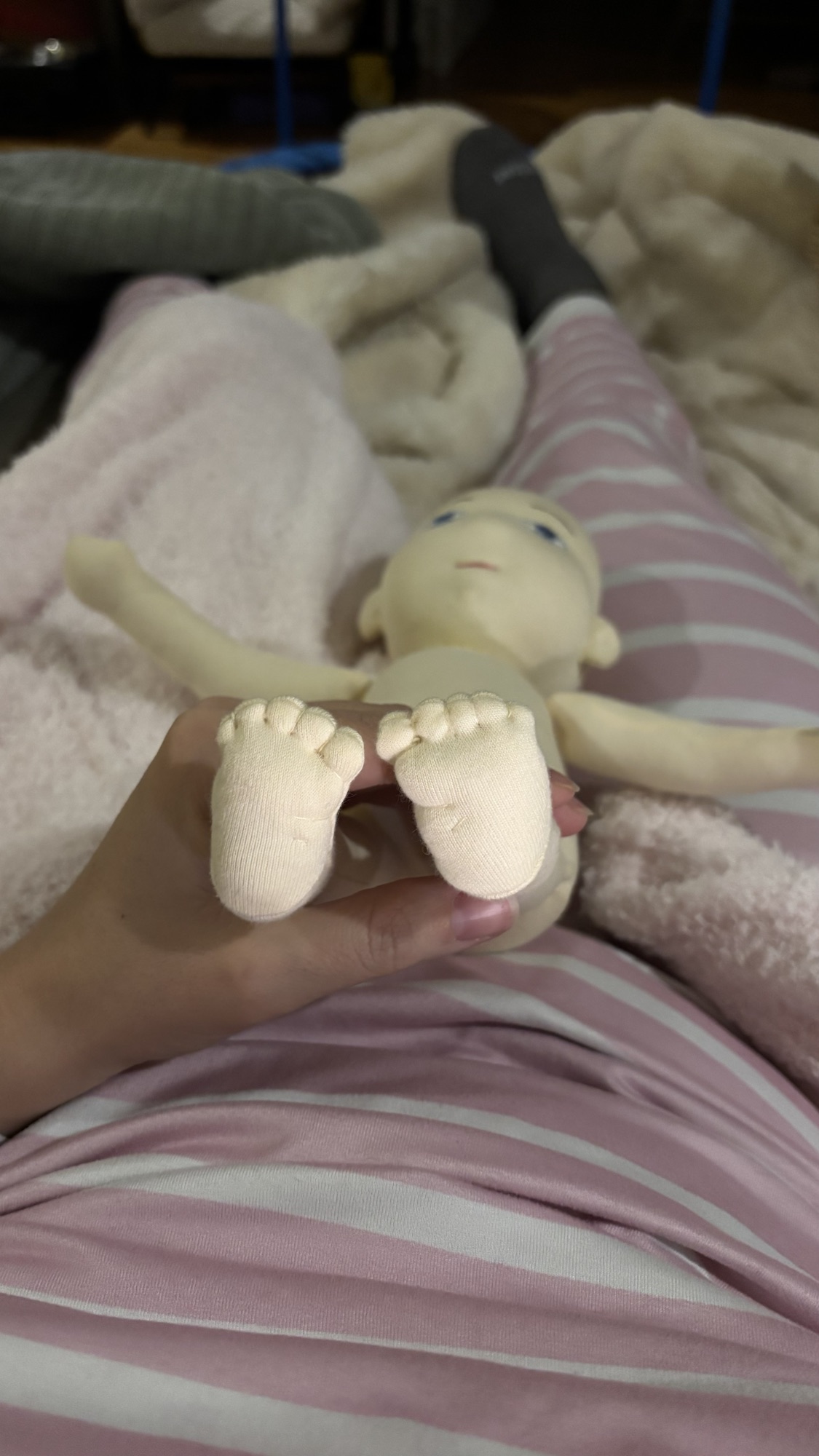 Close view of a handmade cloth doll during construction.