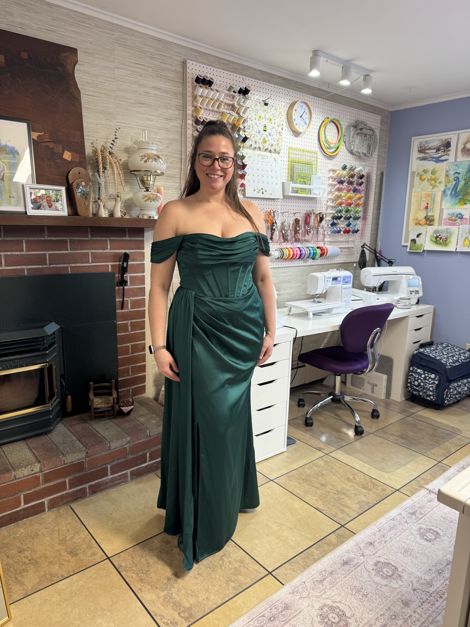 Handmade deep green formal gown displayed in a sewing studio.
