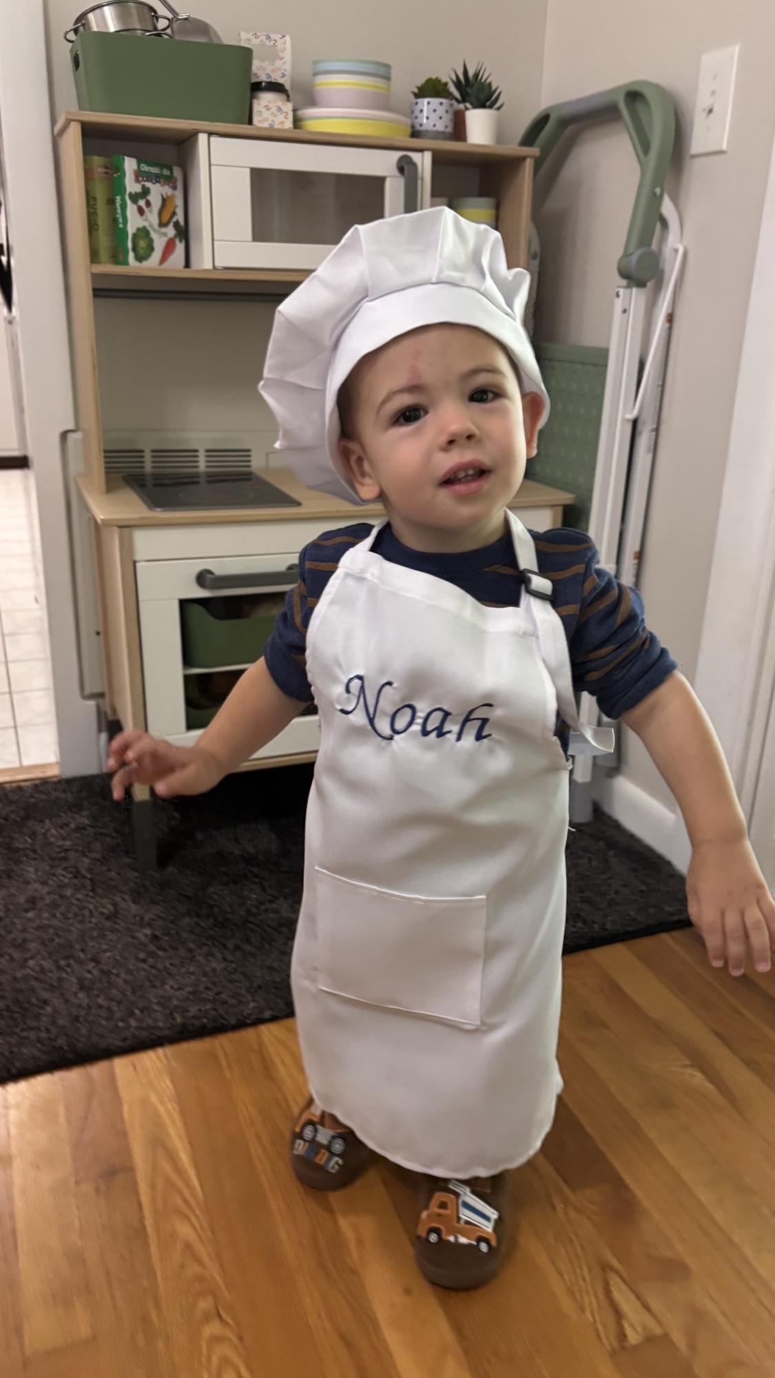 Child wearing a personalized handmade chef hat and apron.