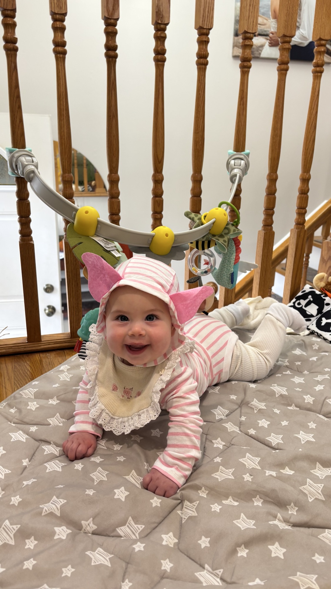 Baby wearing a handmade pink striped fairy costume with wings and hat.
