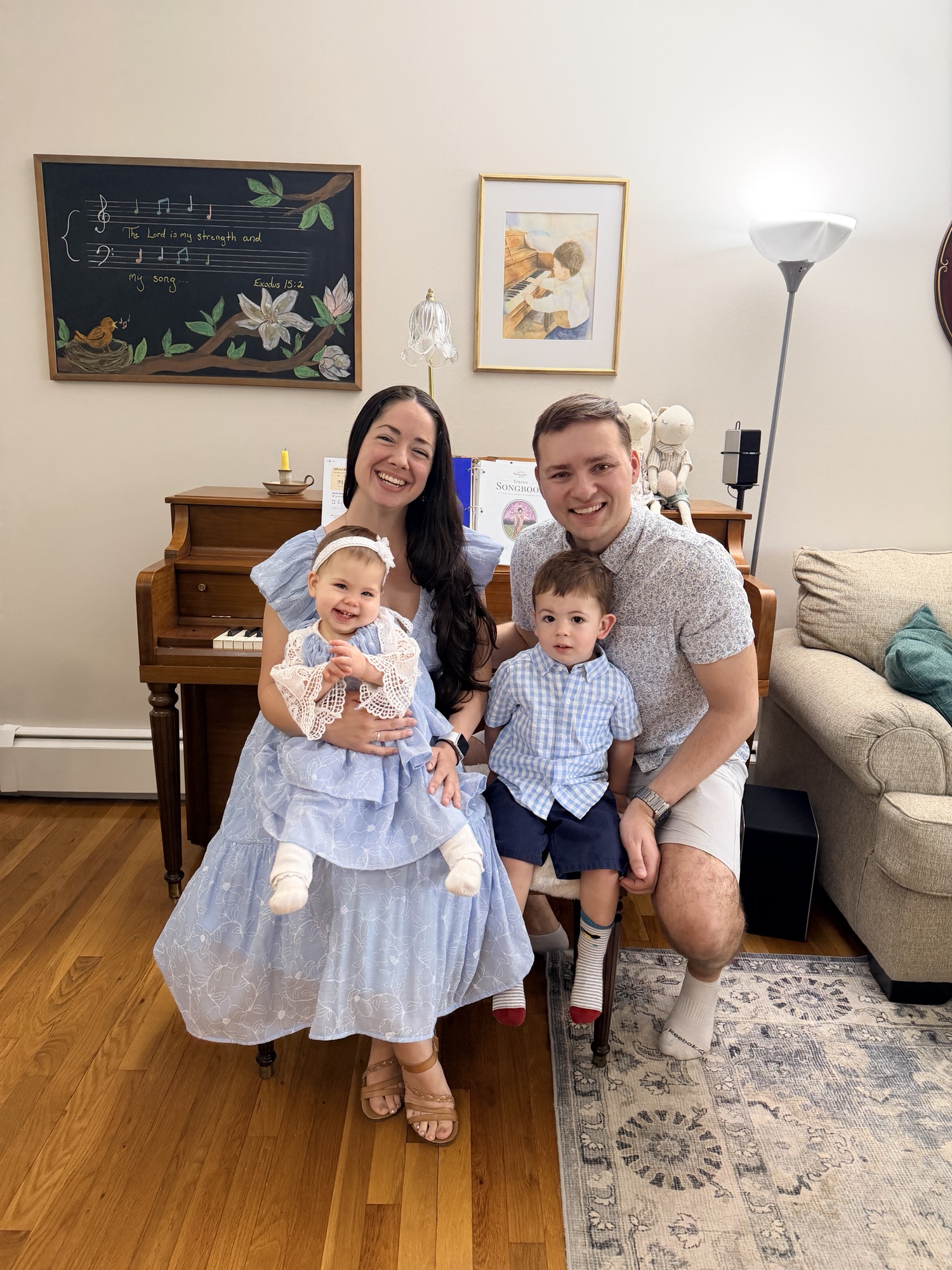 Family wearing coordinated handmade garments in a home sewing space.