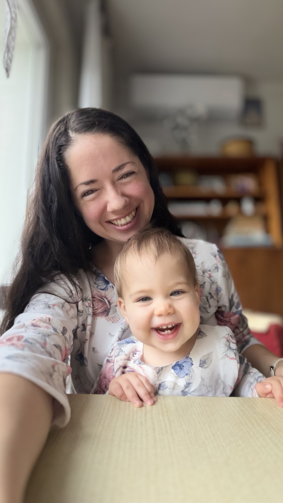 Brooke and her child wearing softly patterned handmade clothing.