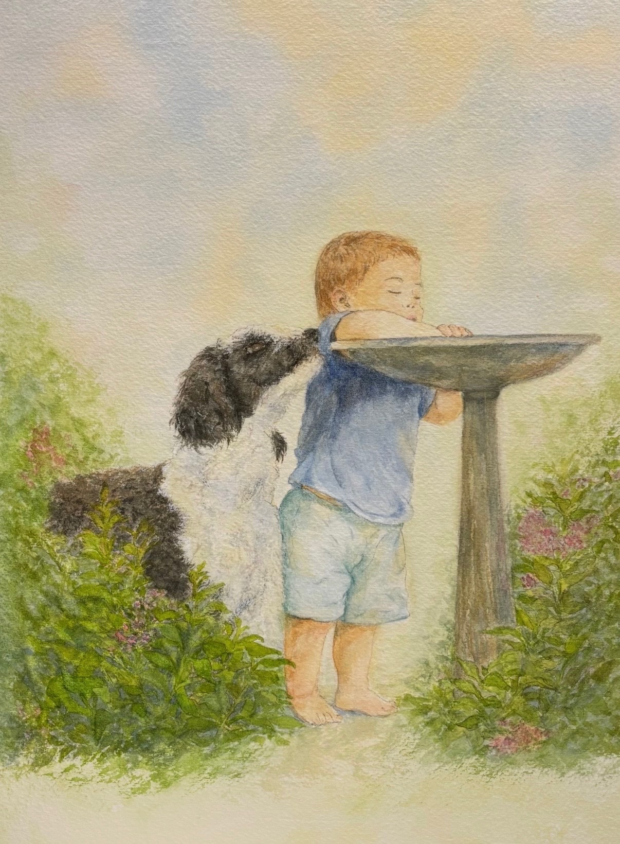 Watercolor painting of a child and dog beside a birdbath in a garden.